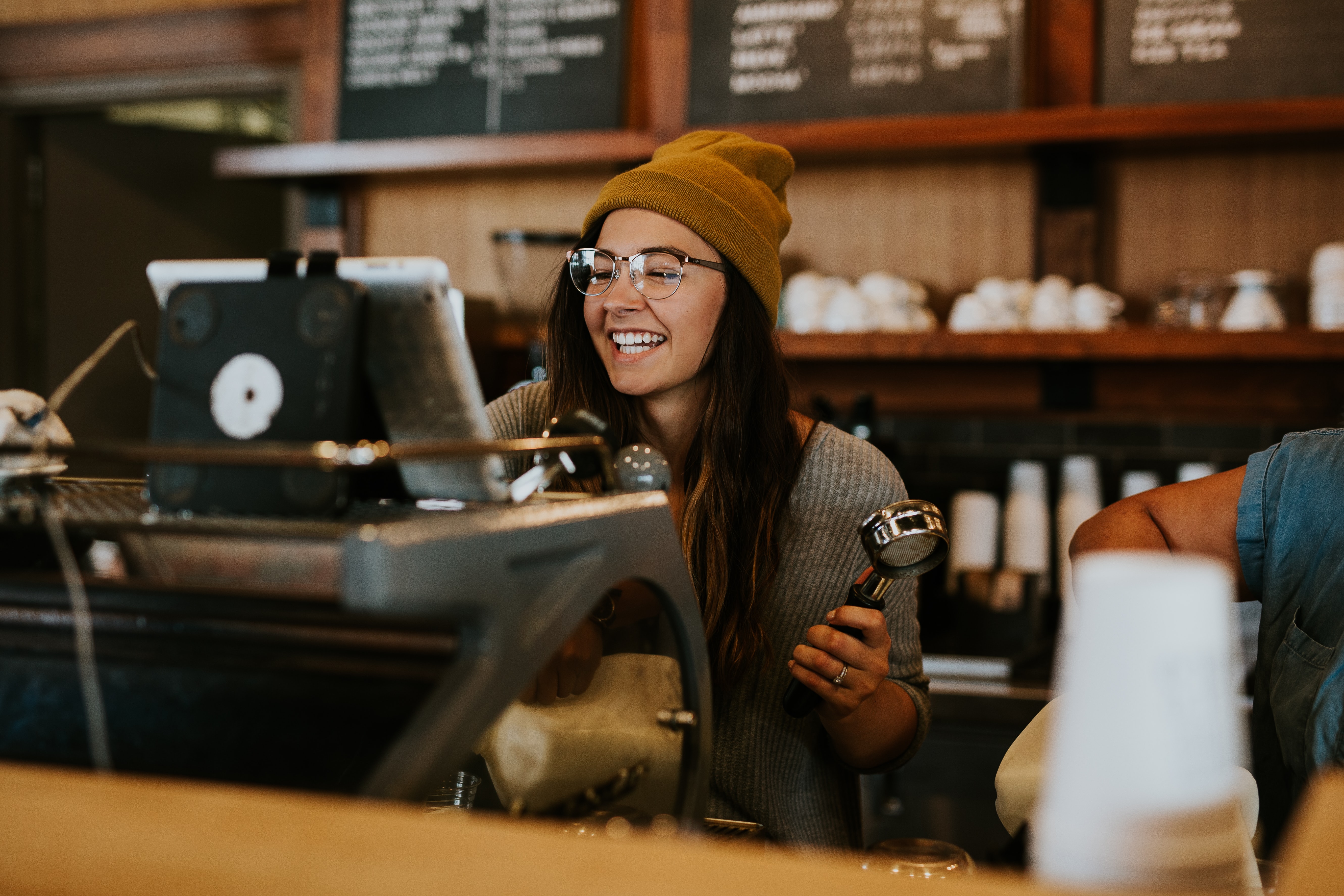 smiling barista working at espresso machine